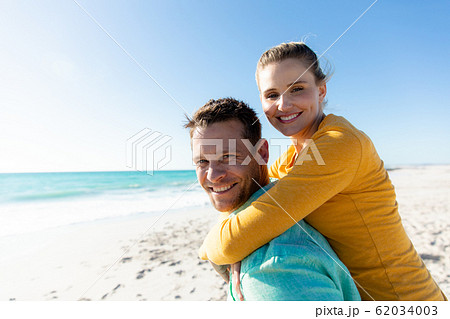 Couple having fun at the beach 62034003
