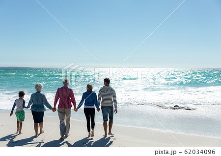 Family walking towards the water 62034096
