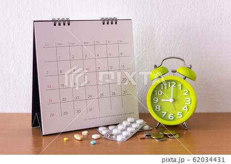 Calendar and drugs on table. 62034431