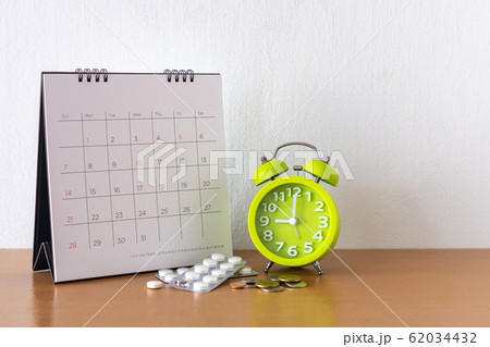 Calendar and drugs on table. 62034432