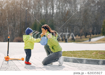 Cute and stylish family in a spring park Cute and stylish family in a spring park 62035927