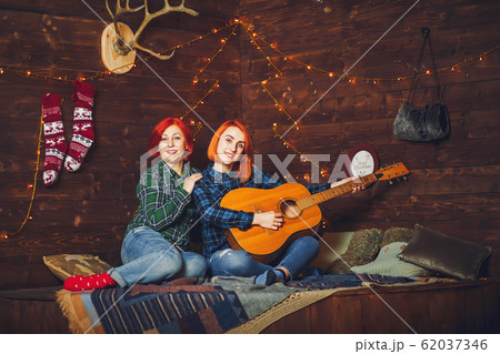 Mother with cute son sitting at home Mother with cute son sitting at home 62037346
