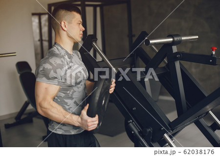 A handsome man is engaged in a gym A handsome man is engaged in a gym 62038176