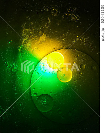 bubble oil on the water look like planet in the space, with colour full light in dark background. bubble oil on the water look like planet in the space, with colour full light in dark background. 62041109