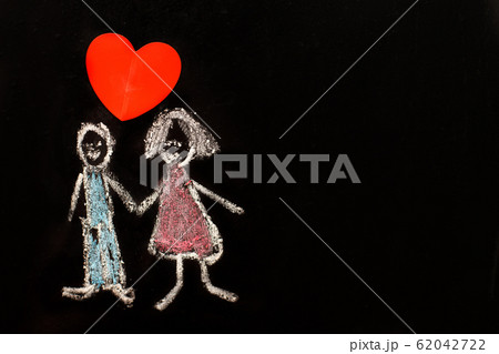 chalk drawing man and woman with red heart on the blackboard. chalk drawing man and woman with red heart on the blackboard. 62042722