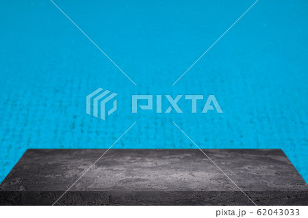 Stone surface on blurry blue background. Stone surface on blurry blue background. 62043033