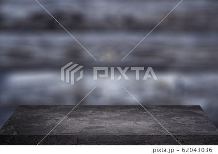 Black stone surface on grey wooden background 62043036