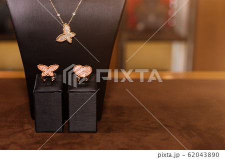 Necklace and rings made of gold with diamonds on a Necklace and rings made of gold with diamonds on a 62043890