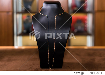 Necklace made of gold with diamonds on a stand in 62043891
