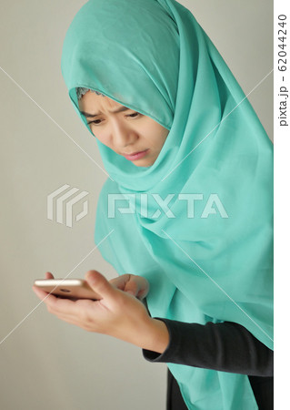 sad, upset, frustrated muslim woman with smart 62044240