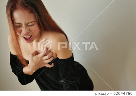 woman suffering from acute heart attack 62044766