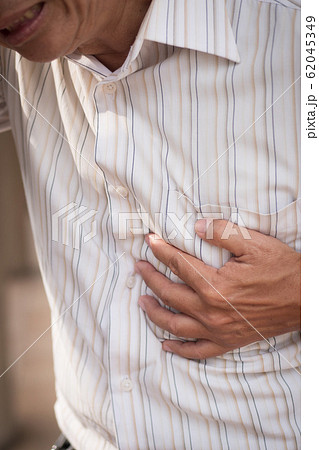 senior old man heart attack, hand holding chest 62045349