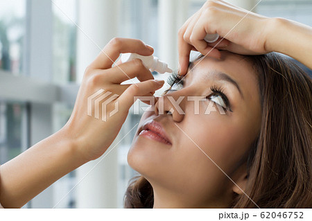 woman using eye drop, eye lubricant to treat dry woman using eye drop, eye lubricant to treat dry 62046752