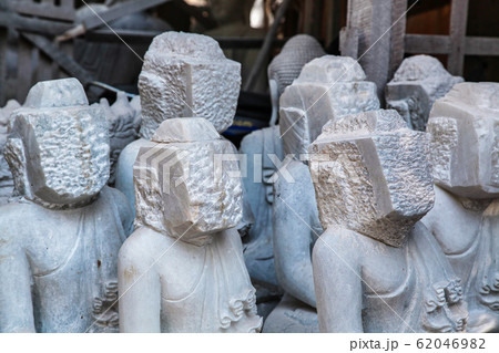 carving Buddha statues from stone in a street carving Buddha statues from stone in a street 62046982