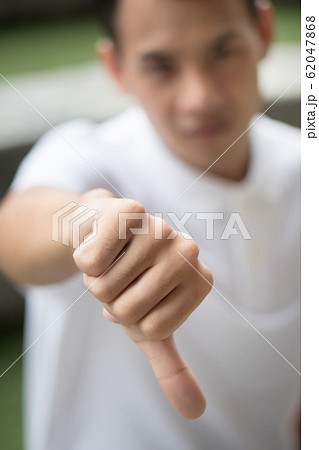rejecting man showing thumb down gesture; man rejecting man showing thumb down gesture; man 62047868
