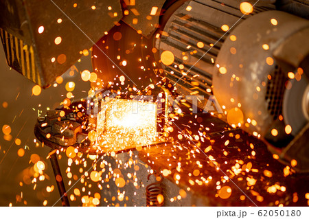 Cutting industrial metal with grinder. Sparks while grinding iron 62050180