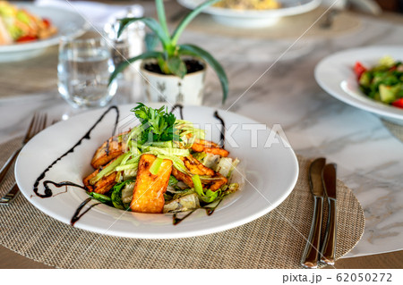 A delicious grilled or roasted hellumi cheese salad is served in a elegance restaurant or hotel. A delicious grilled or roasted hellumi cheese salad is served in a elegance restaurant or hotel. 62050272