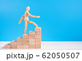 Wooden man walk up the career stairs. 62050507