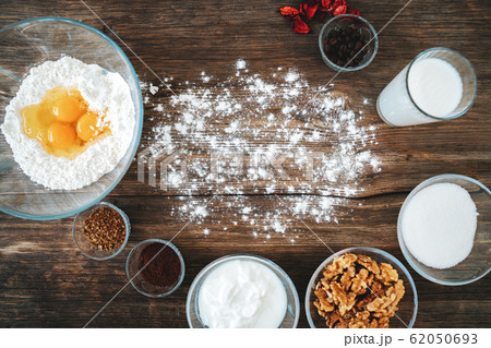 Bakery preparation in kitchen, dough recipe ingredients on vintage wood table from above. Bakery preparation in kitchen, dough recipe ingredients on vintage wood table from above. 62050693
