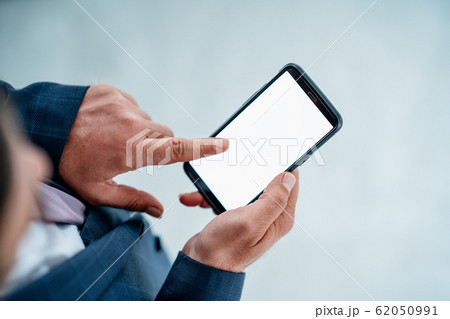Bussinesman checking his smartphone about business, reports, financial etc. Screen mockup concept. Bussinesman checking his smartphone about business, reports, financial etc. Screen mockup concept. 62050991