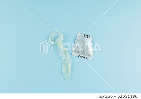 Used condom on blue background. Healthcare, safe 62051186