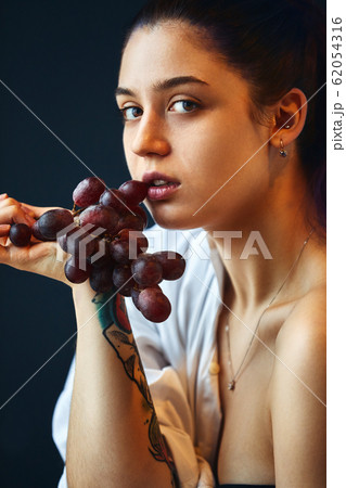 Art portrait of a girl with a vine. Art concept.. Fashion art concept, beauty, creative people freelance people Art portrait of a girl with a vine. Art concept.. Fashion art concept, beauty, creative people freelance people 62054316