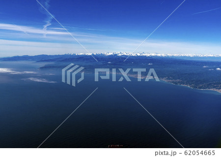 Liguria coast with snowy alps aerial panorama 62054665
