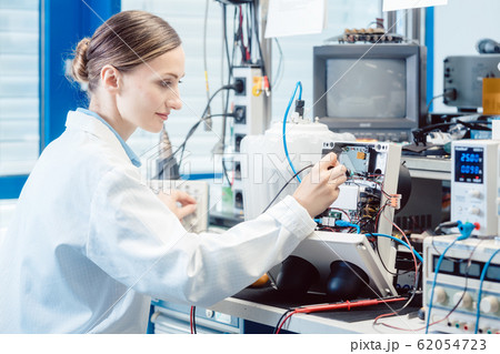 Engineer woman measuring electronic product on test bench Engineer woman measuring electronic product on test bench 62054723