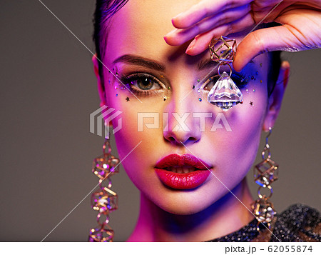 Portrait of beautiful young woman with bright 62055874