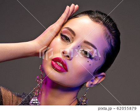 Portrait of beautiful young woman with bright 62055879