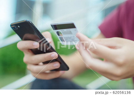 Close-up human hands with mobile phone and credit Close-up human hands with mobile phone and credit 62056136