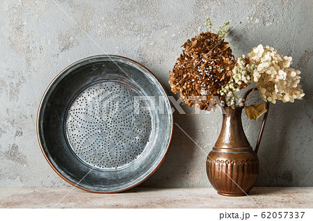 Antique copper sieve on concrete background. 62057337