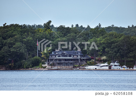 Building in a grassy area on the coast of a lake 62058108