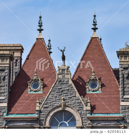 Detail of two equal red brick towers, in a stone 62058113