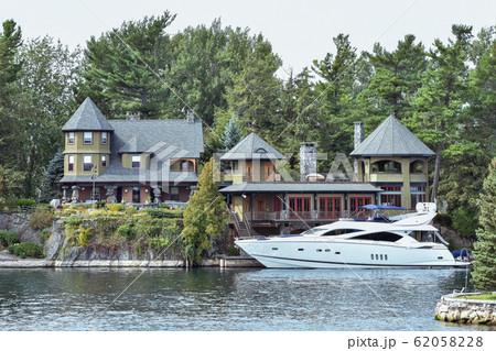 Building in a grassy area on the coast of a lake 62058228