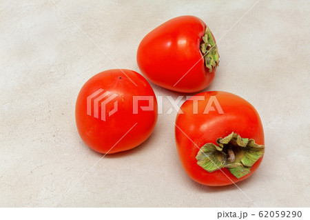 fruits of orange persimmon on the table, colorful dessert, top view 62059290