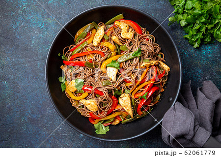 Japanese dish buckwheat soba noodles with chicken and vegetables carrot, bell pepper and green beans Japanese dish buckwheat soba noodles with chicken and vegetables carrot, bell pepper and green beans 62061779