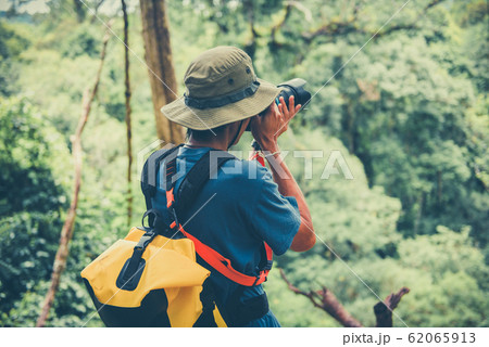 Outdoor adventure and Traveler man holding camera Outdoor adventure and Traveler man holding camera 62065913