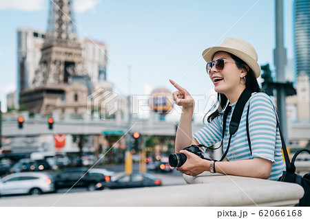 tourist pointing view with curiously smiling tourist pointing view with curiously smiling 62066168