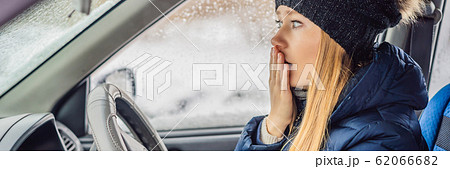 Woman in a car during a snowfall, problems on the road BANNER, LONG FORMAT Woman in a car during a snowfall, problems on the road BANNER, LONG FORMAT 62066682