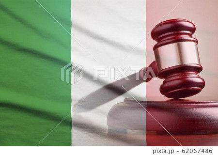 Legal gavel over a flag of the Italy 62067486