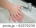 happy woman handwash; closeup hand portrait of 62070236