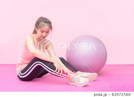 Caucasian female having pain ankle while workout 62072560