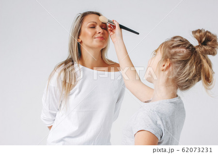 Young beautiful blonde mom and daughter in pajamas 62073231