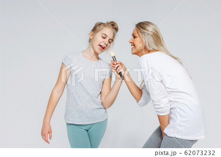 Young beautiful blonde mom and daughter in pajamas Young beautiful blonde mom and daughter in pajamas 62073232