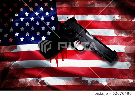 handgun with blood stain on American flag. reform gun control in America concept 62076496