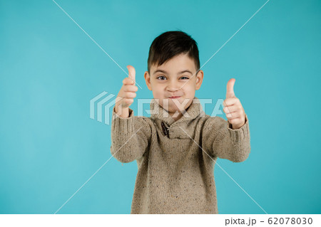 cute little boy making thumbs up gesture cute little boy making thumbs up gesture 62078030