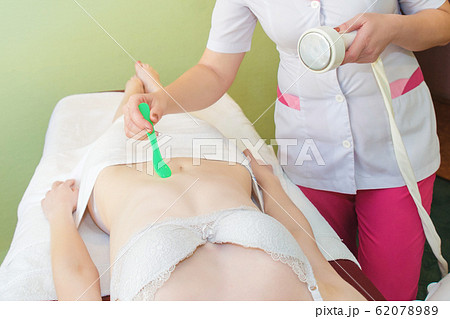 Body massage with cavitation. Young girl on 62078989