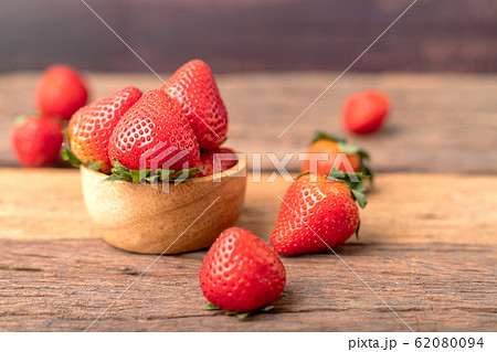 Freshness ripe strawberries are in a wooden bowl Freshness ripe strawberries are in a wooden bowl 62080094