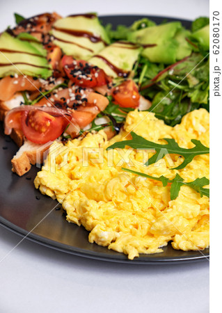 Light breakfast with fried eggs, toast with 62080170